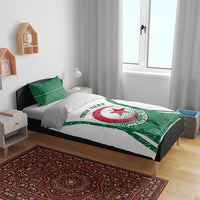 Personalized bedding set on bed: white duvet with green Algeria crest and matching pillows