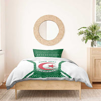 Personalized bedding set on bed: white duvet with green Algeria crest, three-point star