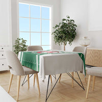 Green Algeria emblem tablecloth draped over dining table with chairs