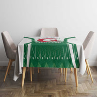 Green Algeria emblem tablecloth on rectangular dining table with side chairs