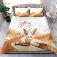 White duvet and pillowcases featuring tan desert clouds and a seated fox face graphic
