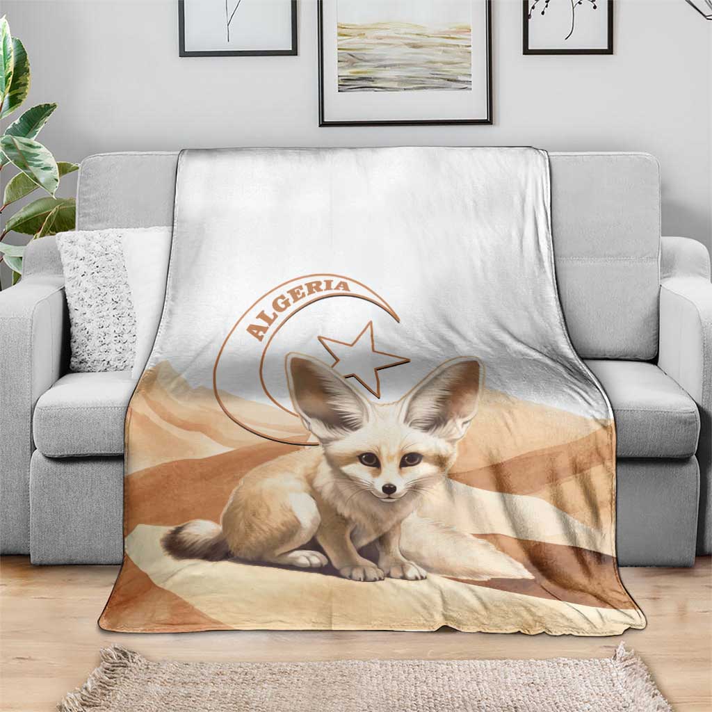 Algeria Sahara throw blanket with dog face and Algeria logo, laid over gray sofa