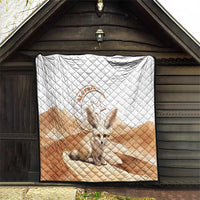 Quilt blanket with white top and tan bottom, diamond pattern, and fennec fox badge