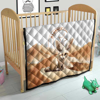 Kids quilt blanket with white diamond quilting, tan diagonal band, and fennec fox emblem