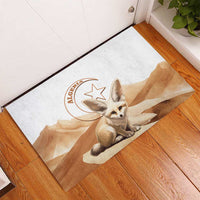 White rubber doormat featuring Algeria stamp and fennec fox sitting on desert scene