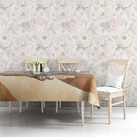 White tablecloth with fennec fox and tan desert print across a dining table surface.