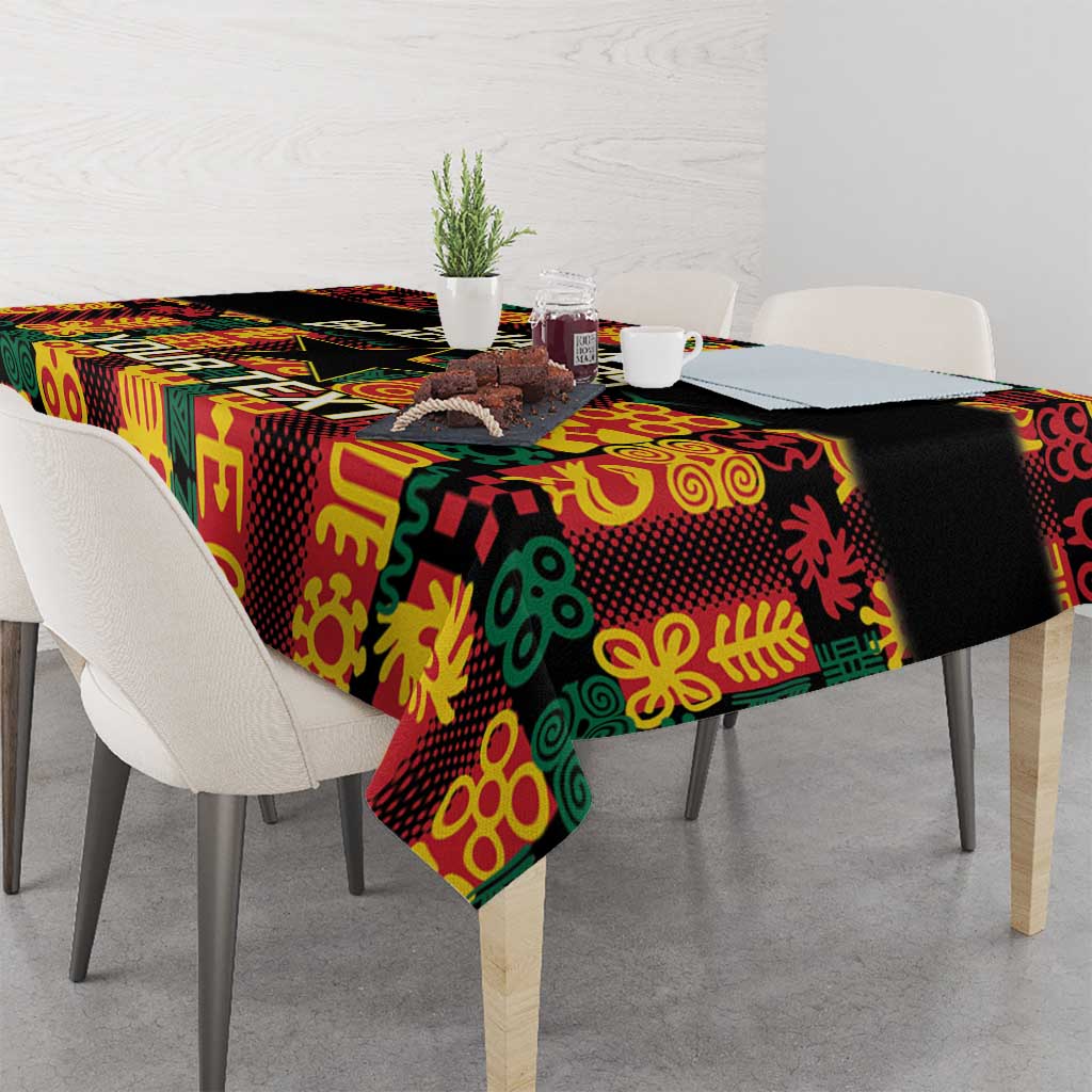 Black tablecloth with bold multicolor Adinkra motifs and corner drape