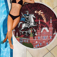 Close-up round red beach blanket with fringe, Moscow towers and knight-on-horse print