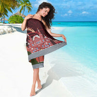 Red Moscow map sarong with city skyline print and gray border, draped on beach