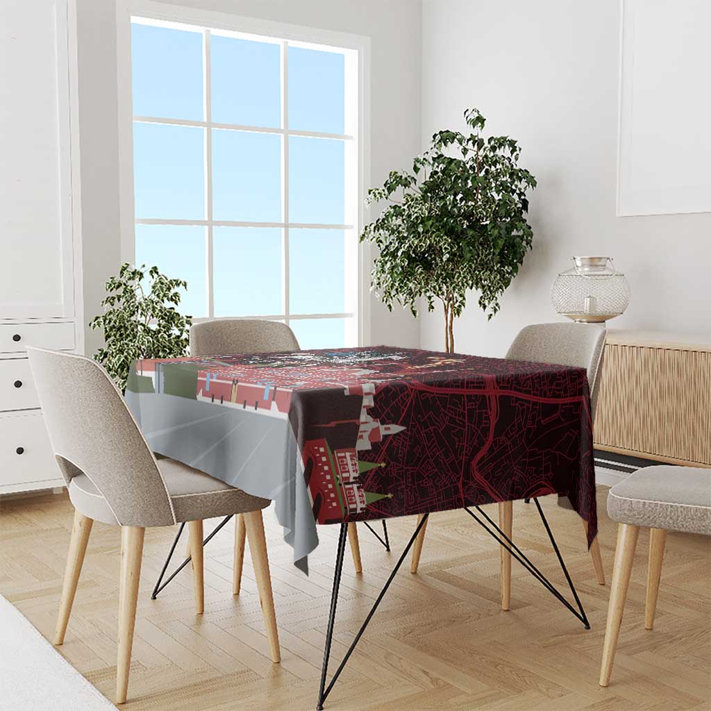 Red tablecloth with cityscape map print, draped over dining table and chairs