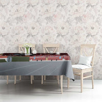 Red and gray tablecloth with skyline map print, over dining table surface