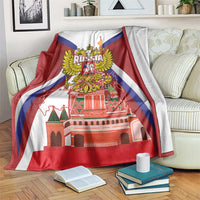 Red blanket with Russia coat of arms and St Basil cathedral print, draped on sofa