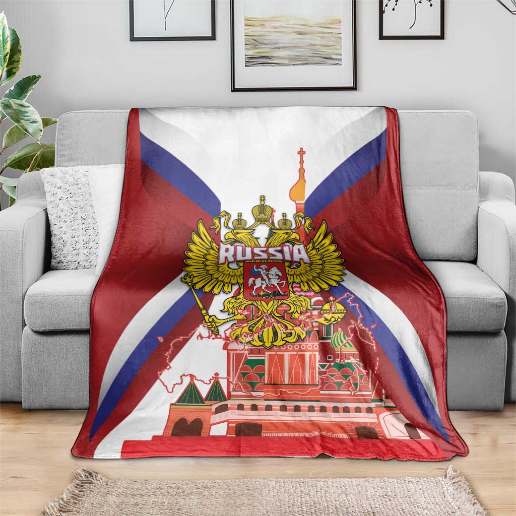 Red blanket with Russia coat of arms and St Basil cathedral print, laid across couch
