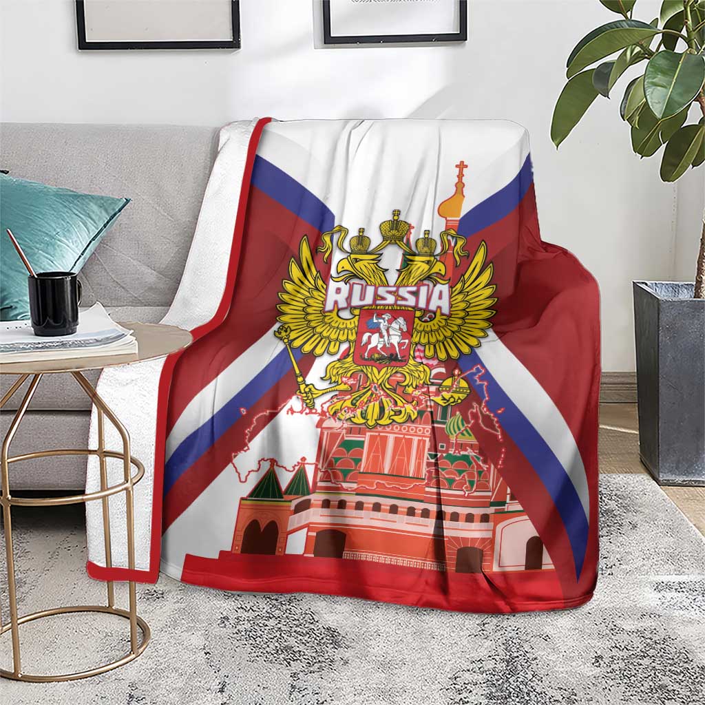 Red blanket with Russia coat of arms and St Basil cathedral print, covering couch seat