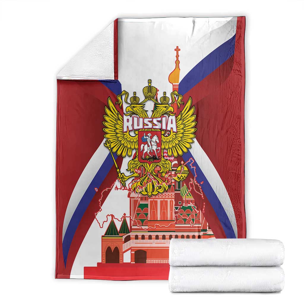 Folded red blanket with Russia coat of arms and St Basil cathedral print, with rolled towels