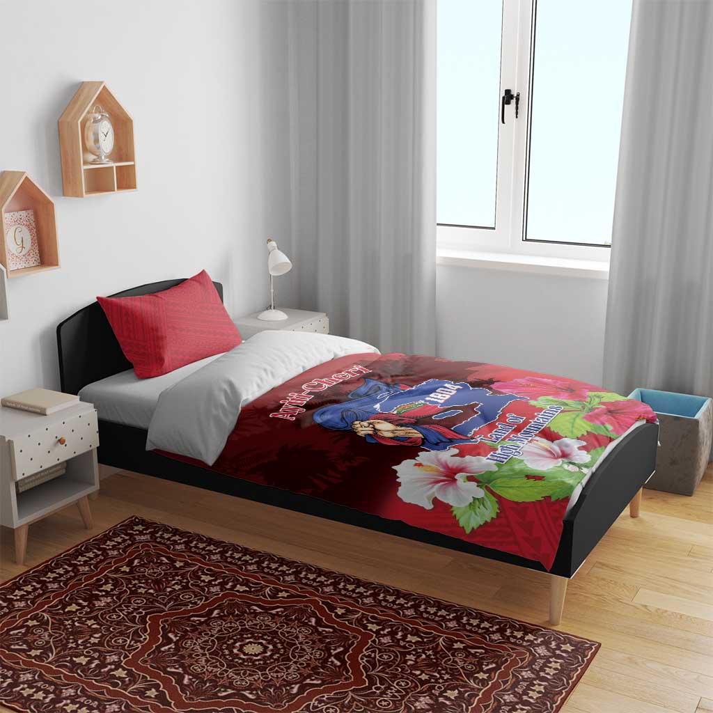 Red duvet cover with mountain crest and large white flowers, set on bed with two pillows