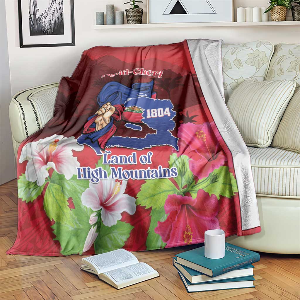 Red decorative blanket with map graphic, woman figure, and 'Land of High Mountains' text