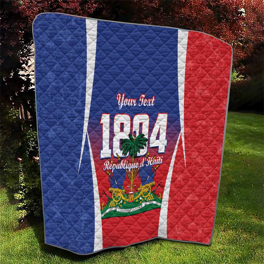 Personalized Haiti 1804 quilt folded on grass, blue and red sides with white vertical stripe