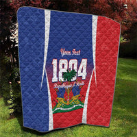 Personalized Haiti 1804 quilt folded on grass, blue and red sides with white vertical stripe