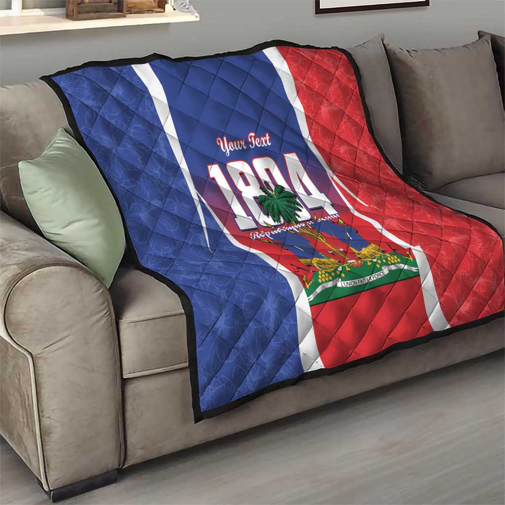 Personalized Haiti 1804 quilt on gray sofa, diagonal folds over blue and red flag panels