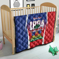 Personalized Haiti 1804 quilt on baby bed, blue-red flag design with white vertical stripe