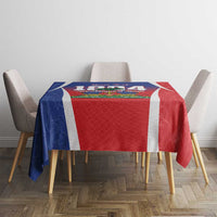 Tablecloth with blue and red sections, white stripe border, and Haiti-themed printed center