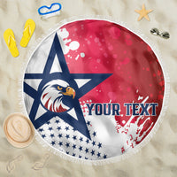 Circular beach blanket with navy eagle graphic, red background, and white fringe edge