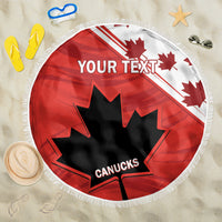 Red round beach blanket with fringe, 'YOUR TEXT' and Canucks maple leaf on sand