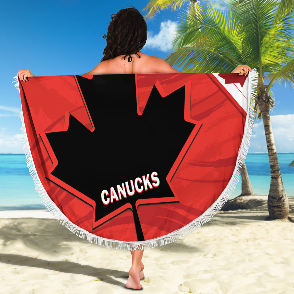 Red circular beach blanket with fringe, black maple leaf and Canucks logo, full view