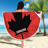 Red circular beach blanket with fringe, black maple leaf and Canucks logo, full view