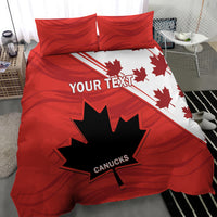Red and white duvet cover with maple leaf and star graphic; two red pillow shams.