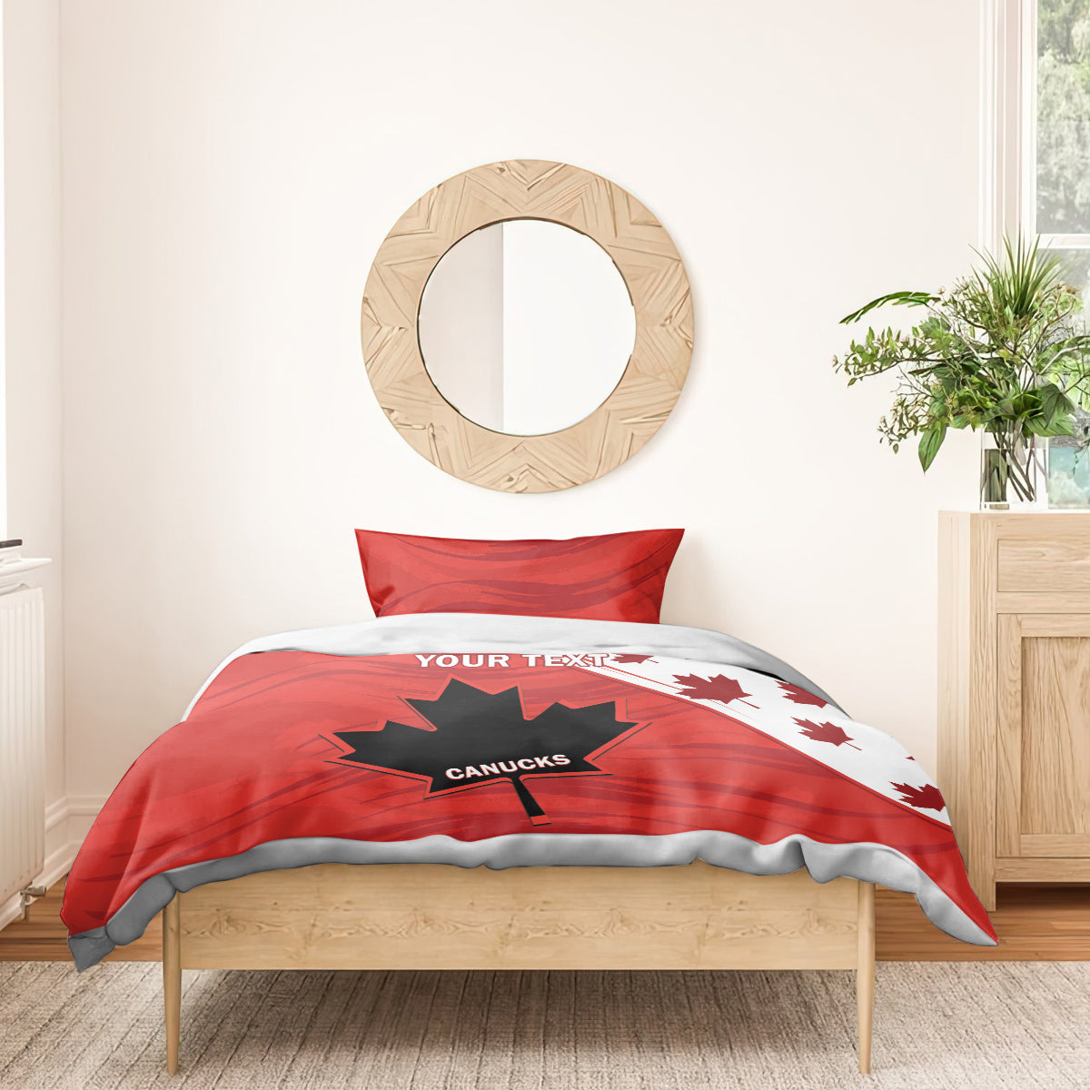 Red duvet cover with maple leaf and star graphic on bed; two pillow shams.