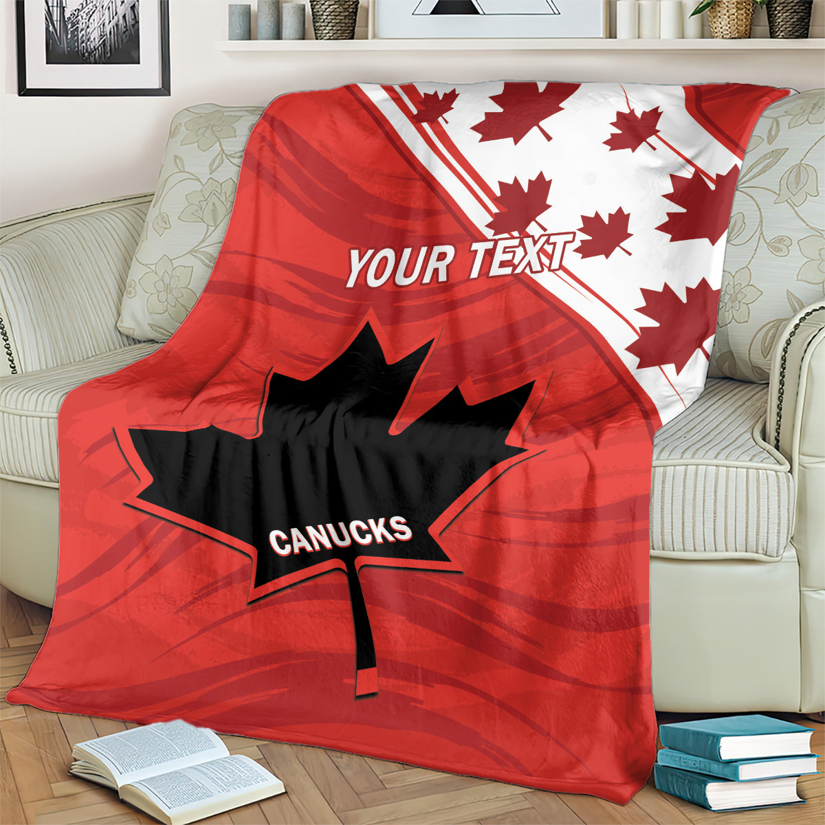 Red blanket with maple leaves, diagonal stripe, and CANUCKS logo, covering armchair