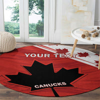 Red round rug featuring black maple leaf, CANUCKS lettering, and YOUR TEXT along stripe