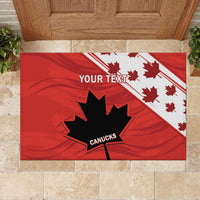 Red doormat on stone floor with black maple leaf, 'YOUR TEXT' banner, and 'CANUCKS'