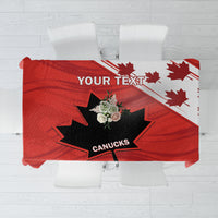 Red tablecloth with Canucks logo and maple leaf design