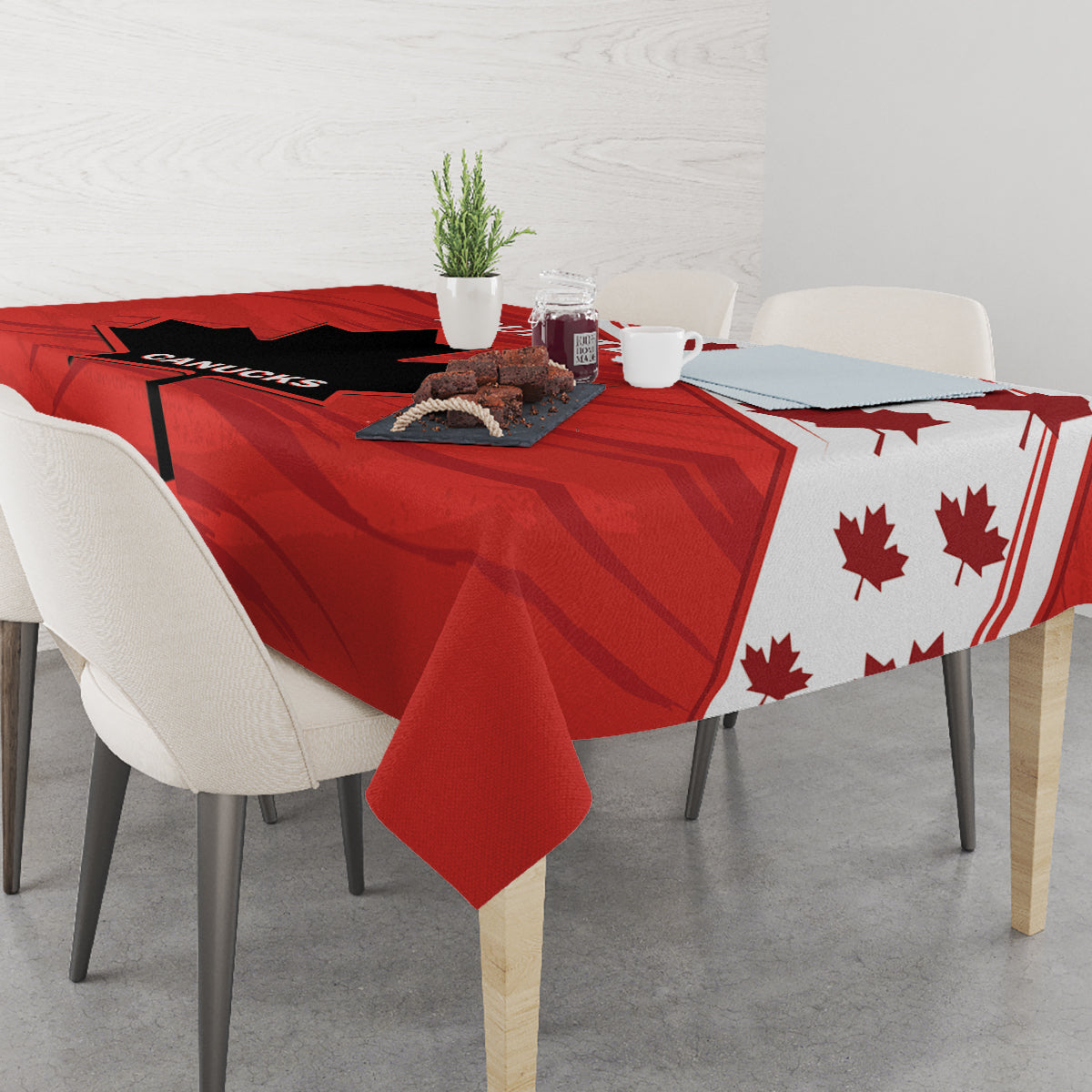 Red tablecloth on dining table with black panels and maple leaf pattern