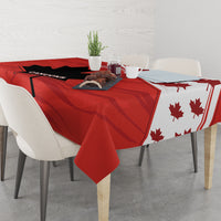 Red tablecloth on dining table with black panels and maple leaf pattern