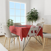Red tablecloth on dining table with maple leaf motif on patterned side