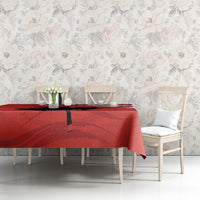Red tablecloth on dining table with black accent stripe and maple leaf pattern