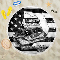 Round black-and-white beach blanket with fringed edge and alligator graphic design