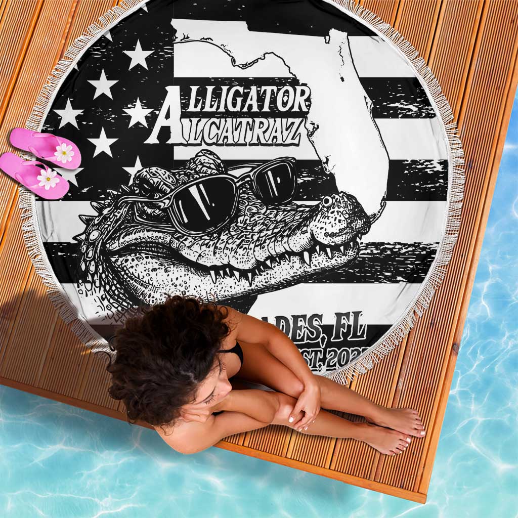 Folded round beach blanket with fringed edge, black-and-white alligator and star pattern