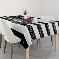 Black and white tablecloth with distressed vertical stripe pattern over dining table