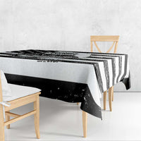Black and white striped tablecloth with draped edge hanging over table corner