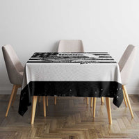 Black and white striped tablecloth on rectangular dining table with matching chairs