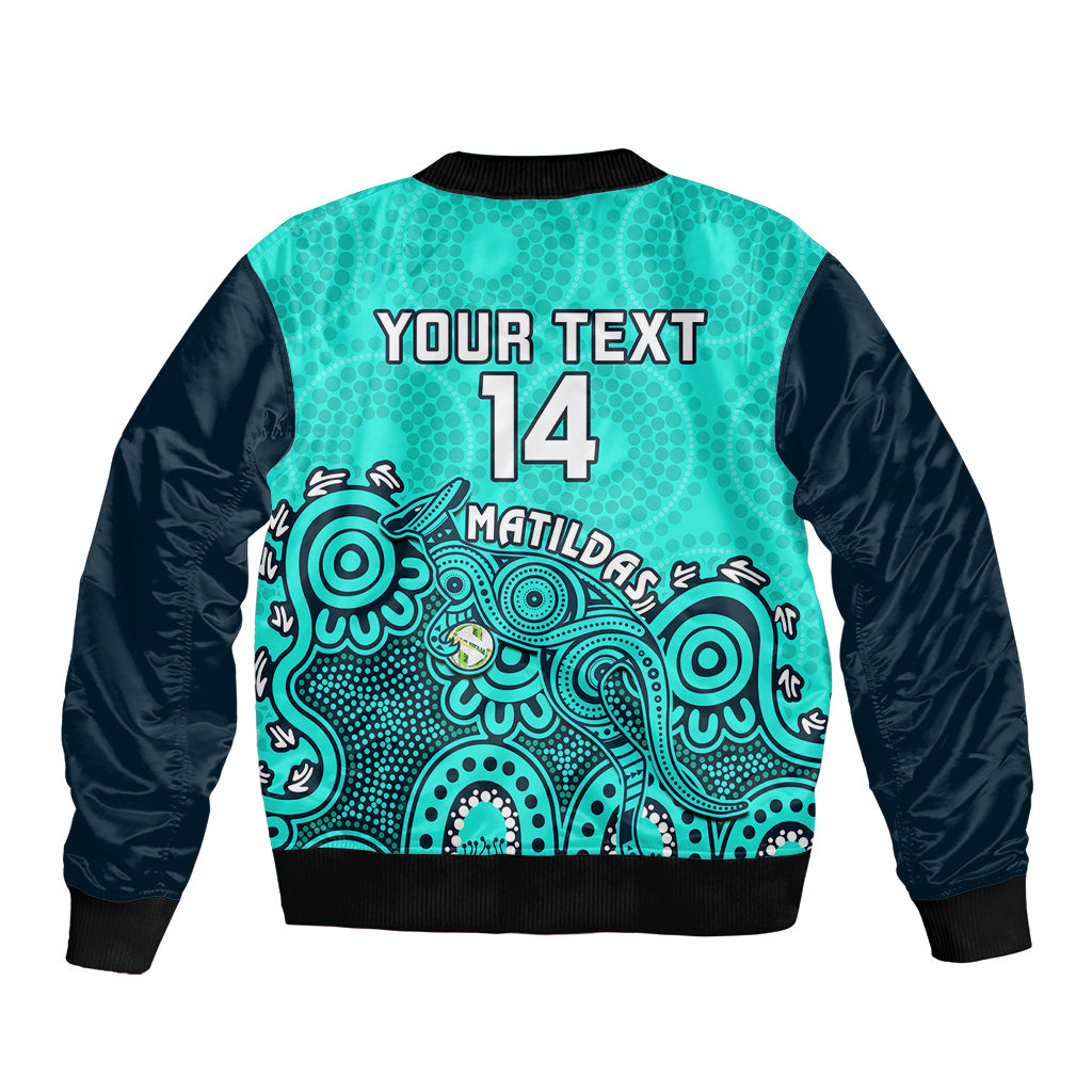 Turquoise and black bomber jacket with back text 'YOUR TEXT 14' and Aboriginal artwork
