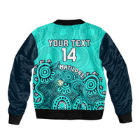Turquoise and black bomber jacket with back text 'YOUR TEXT 14' and Aboriginal artwork