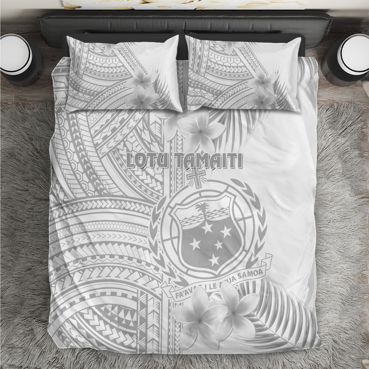 White toddler bedding set with grey Polynesian crest, plumeria flowers, and patterned panels