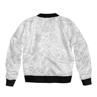 White bomber jacket with tropical leaf/flower print on back, black ribbed collar, cuffs, hem.