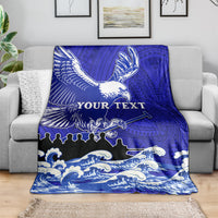 Blue eagle race blanket with Polynesian pattern and waves, draped on a sofa with "YOUR TEXT"